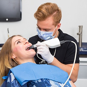 Dentist taking digital impressions of a patient’s smile