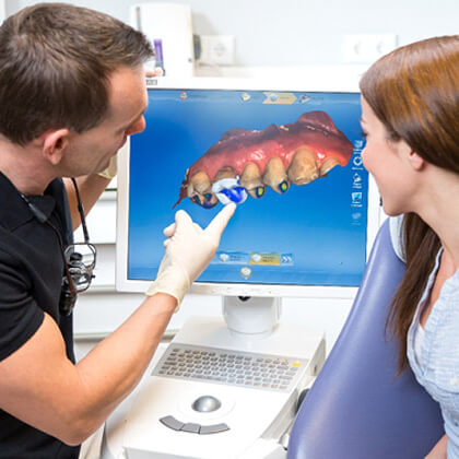 dentist creating digital impression of patients smile