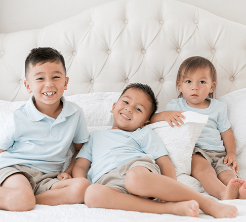 Two Children hugging on couch