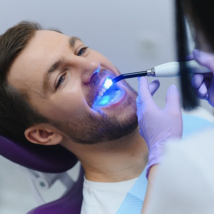 A young man getting tooth-colored fillings