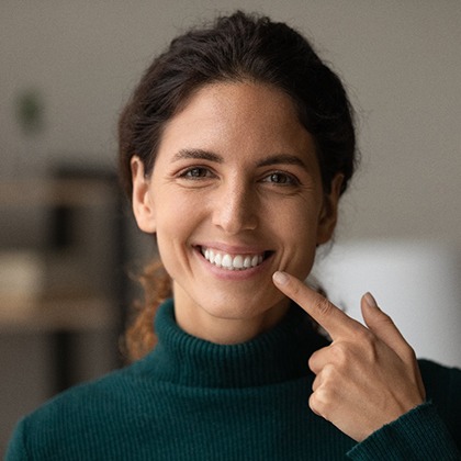 A smiling woman happy with her new tooth-colored fillings