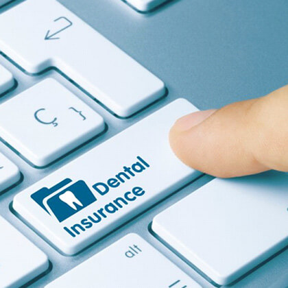 a person pressing a dental insurance keyboard button