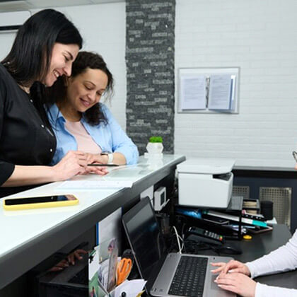 a dental fron desk team helping patient