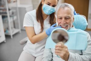 smiling older patient after getting dental implants